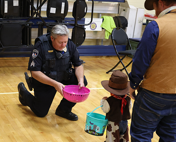 Police Officer giving candy to a trick or treater